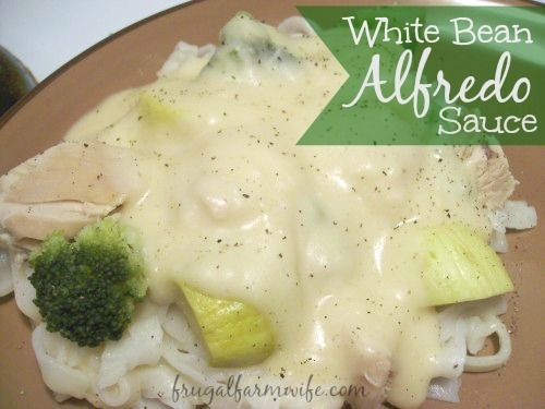 Image shows a plate of pasta and broccoli covered in white sauce, with text that reads "White Bean Alfredo Sauce"