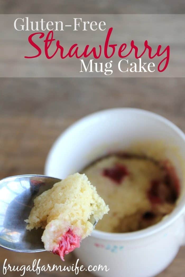 Image shows a close up of a mug with a spoon holding a bite of cake and text overlay that reads "Gluten-free strawberry mug cake"