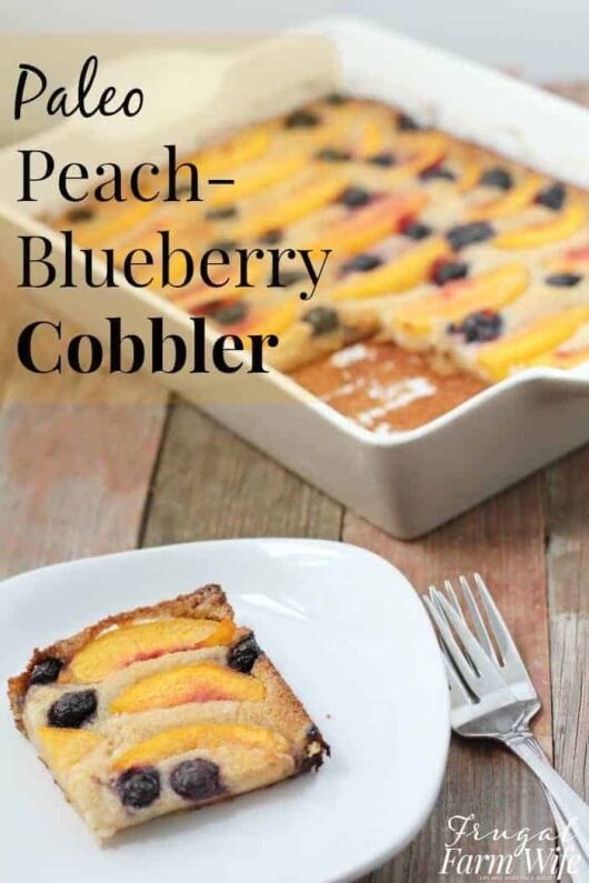 Image shows a pan of peach-blueberry cobbler next to a plate with a slice of cobbler