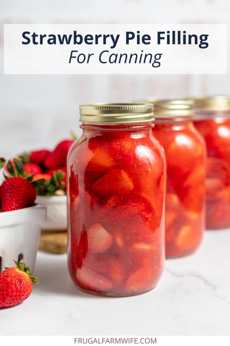 Image shows several canning jars filled with homemade strawberry pie filling. Fresh strawberries sit behind the jars, and text above reads "Strawberry Pie Filling for Canning."